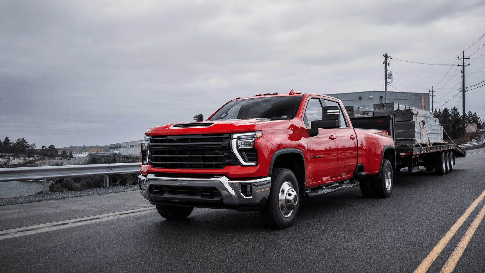 Red heavy-duty pickup hauling a hotshot trailer